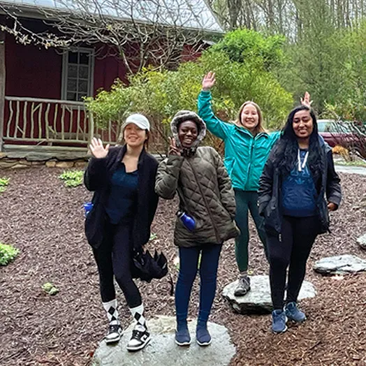 four students standing outdoors