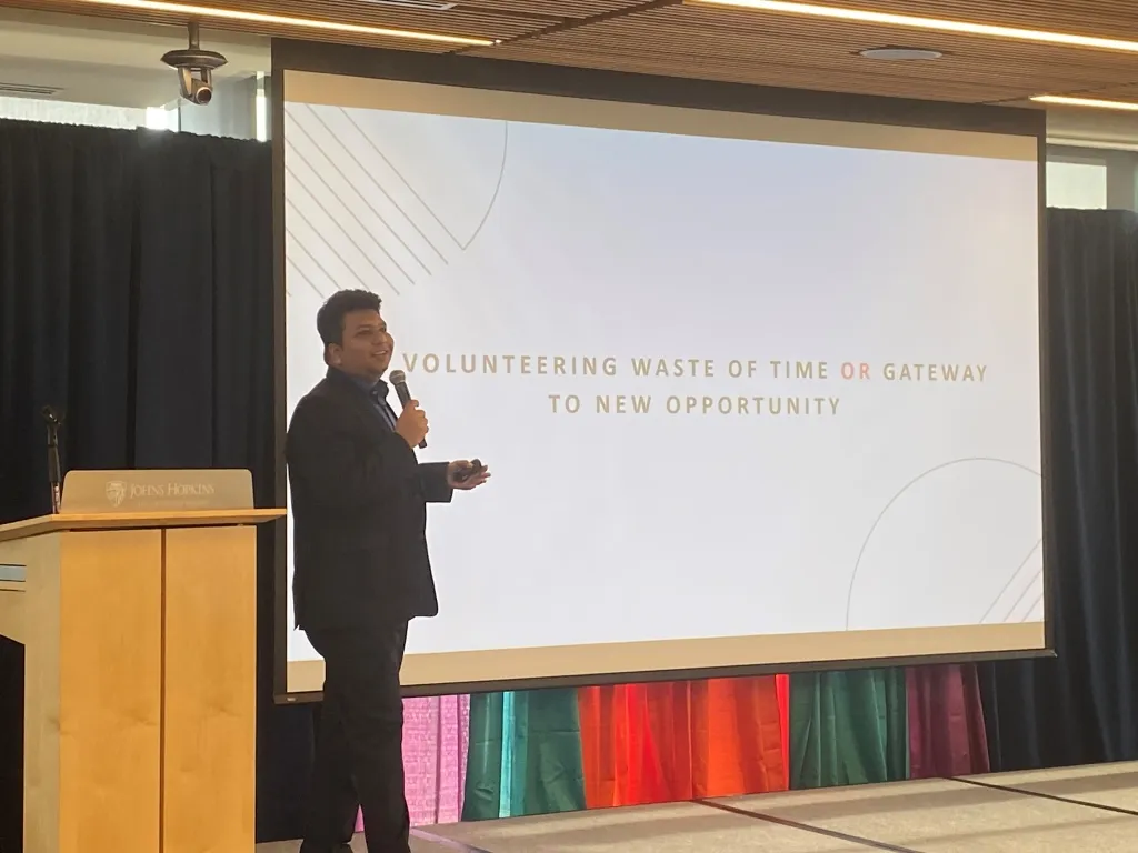 presenter standing in front of screen