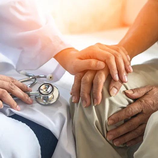doctor's hand holding patient's hand