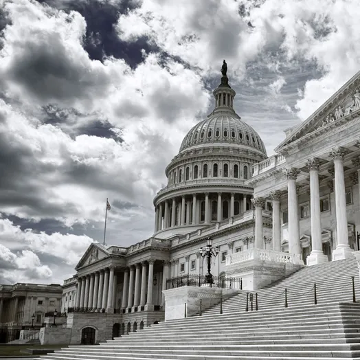 Photo of the Capital building in black and while with ominous clouds over it.. .