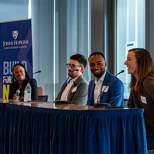 four speakers at a conference table