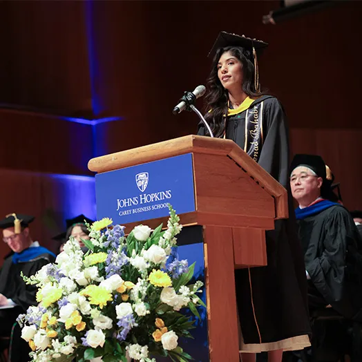 commencement speaker on stage addressing students