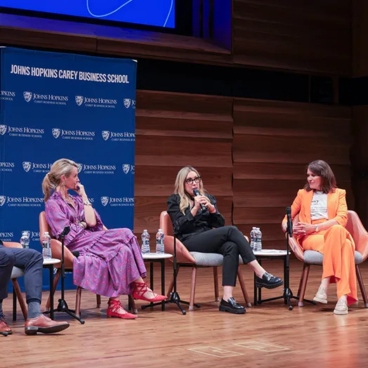 JHU GWI event speakers on stage