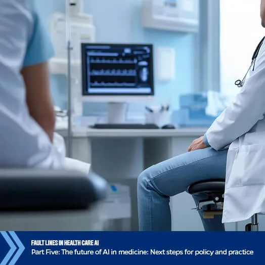 two physicians sitting in a health clinical room with a monitor