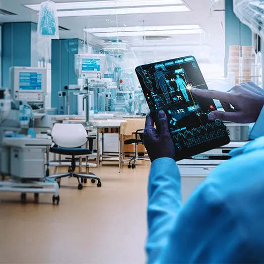 technical researchers in a lab holding a high tech screen with the outline of a human body 